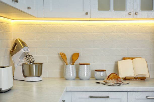 istock Countertop with modern food processor, cookbook and fresh bread in stylish kitchen 1388539376