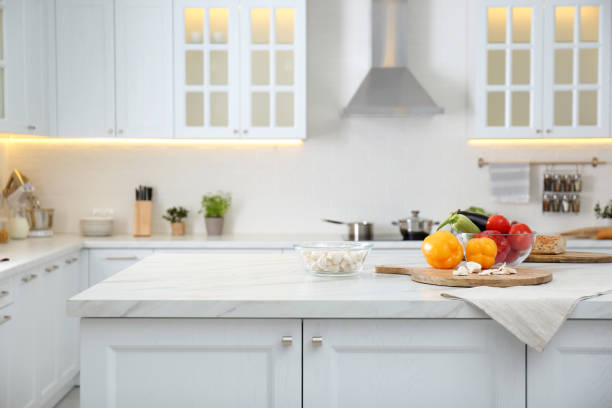 istock Different fresh vegetables and mushrooms on white table in modern kitchen. Space for text 1388539386