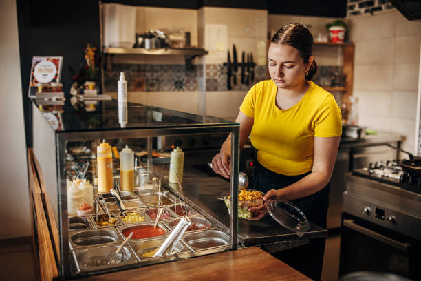 istock Female chef preparing salad 1388541164