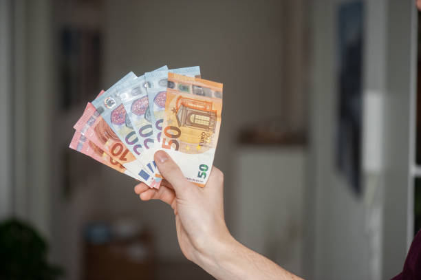istock man holding money 1388541245