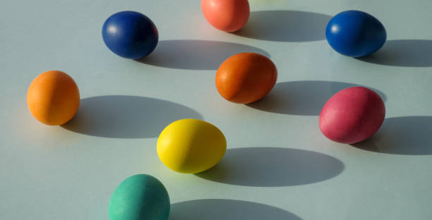 istock Easter eggs on blue background, with sunlight and shadows, close-up 1388541540