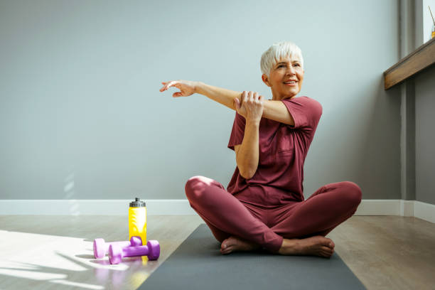 istock Mature woman doing stretching exercises 1388542533
