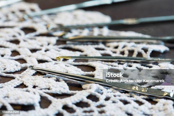 Crochet Hook And Lace Doily On A Wooden Table Stock Photo - Download Image Now - Art, Close-up, Color Image