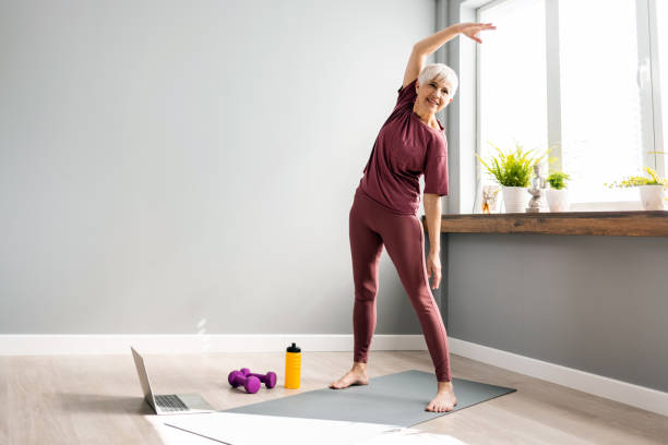 istock Woman doing home workout, warm up exercises 1388542632