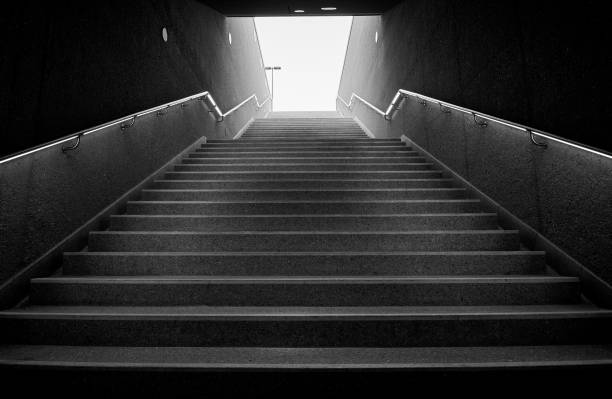 istock Dark underground stairs leading up into the light 1388543740