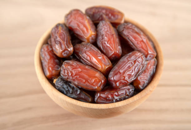 istock Date fruit in bowl on wooden background,directly above 1388545517