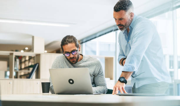 istock Businessmen having a discussion in a modern office 1388545651