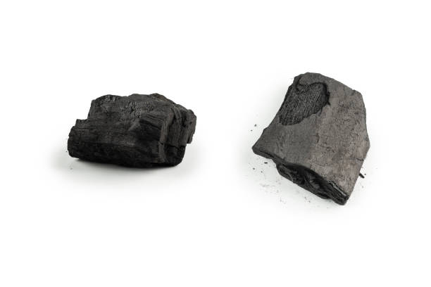 istock Black oak coal isolated on white background. 1388547214