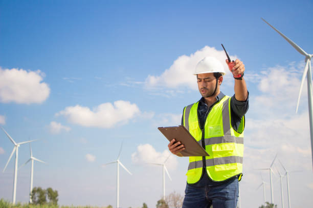 istock engineer team working in wind turbine farm. Renewable energy with wind generator by alternative energy concept. 1388547562