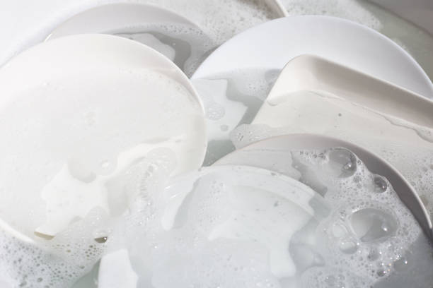 istock Dish washing, Dirty dishes soaking in kitchen sink. 1388547581