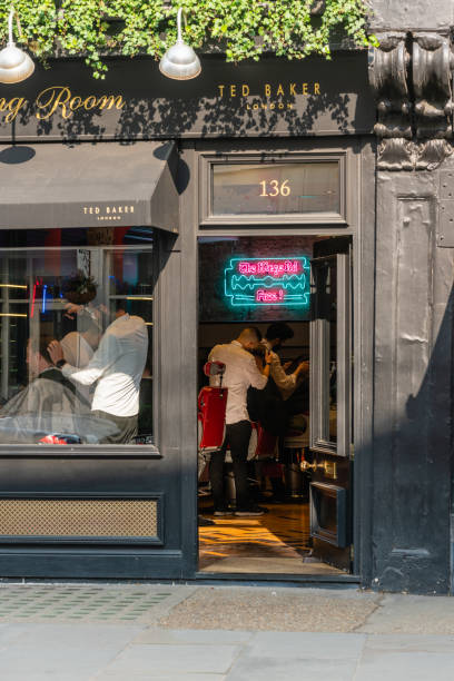 Ted Baker: The Grooming Room, King's Road, Chelsea, London, SW1, UK - March 25th 2022: Luxury Barbershop shot on a sunny day with customer recieve a haircut