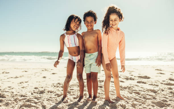 istock Happy young friends having a good time at the beach 1388547726