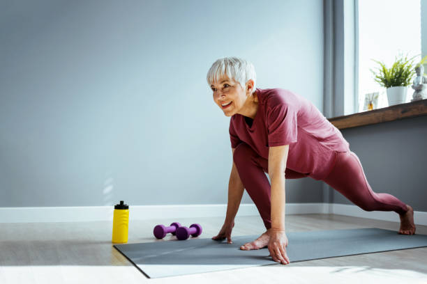 istock Attractive mature woman training indoors working out legs 1388547738