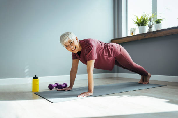istock Woman practicing in plank pose on mat at home 1388547762
