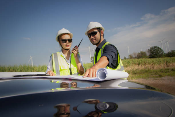 istock engineer team working in wind turbine farm. Renewable energy with wind generator by alternative energy concept. 1388547831
