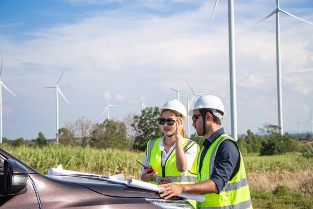 istock engineer team working in wind turbine farm. Renewable energy with wind generator by alternative energy concept. 1388547845
