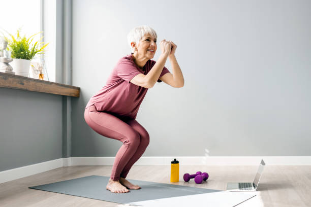 i feel fresh and ready for the day - stretching women attractive female indoors imagens e fotografias de stock