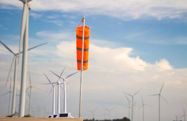 engineer team working in wind turbine farm. Renewable energy with wind generator by alternative energy concept.