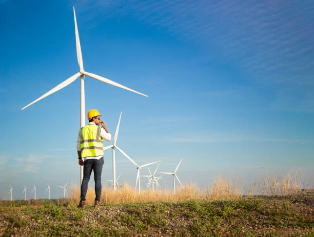 istock engineer team working in wind turbine farm. Renewable energy with wind generator by alternative energy concept. 1388548640