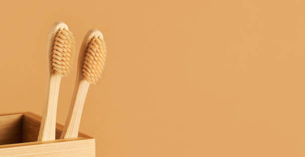 istock Set of bamboo toothbrushes in a bamboo holder on brown background. Eco-friendly, zero-waste concept 1388549314