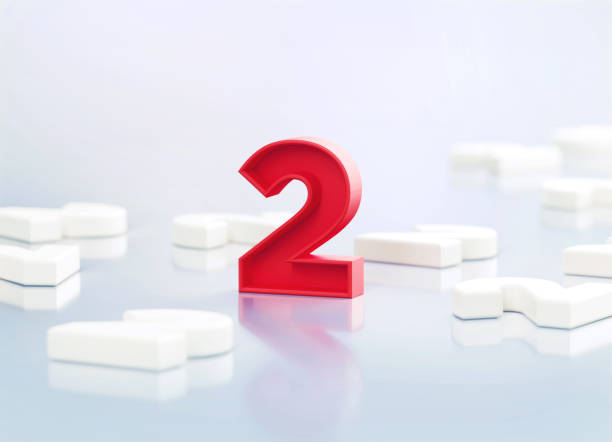 istock Red Number 2 Sitting Amid White Number Twos On White Reflective Background 1388552714