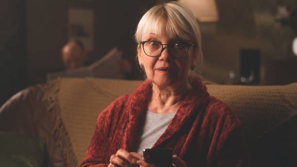 istock Happy elderly female reading good news 1388555335