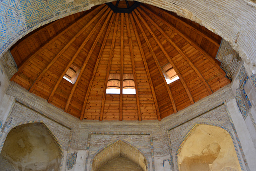 Balkh, Balkh province, Afghanistan: wooden half dome at the Seyyed Sobhan Gholi Khan (1095-1105 AH or 1684-1694 AD) school and mosque - the arch still retains some of the original Persian tiles with square Kufic script decoration - ruined Madressa on the eastern side of central garden, it once had 150 rooms, but only the central building remains - Timurid period architecture.
