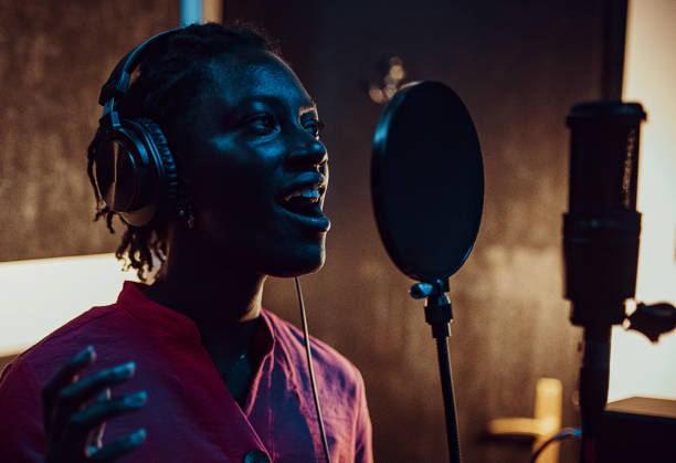 istock Black woman singing and recording in the music studio 1388558921