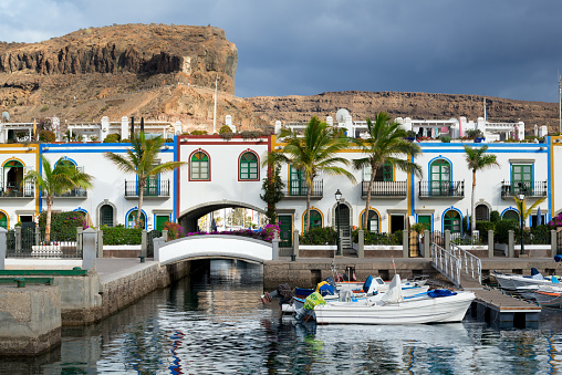 Puerto de Mogan, Gran Canaria, Canary Islands/Spain - 2.06.2018: Beautiful buildings and boats in front of the mountain in Puerto de Mogan, Gran Canaria, Canary Islands, Spain