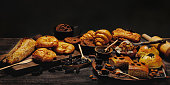 istock Banner of assortment of bread and bakery product on dark background 1388559155
