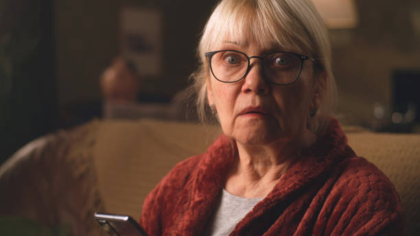 istock Scared aged woman reading shocking news 1388560467