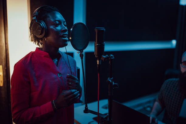 istock Black woman singing and recording in the music studio 1388560607