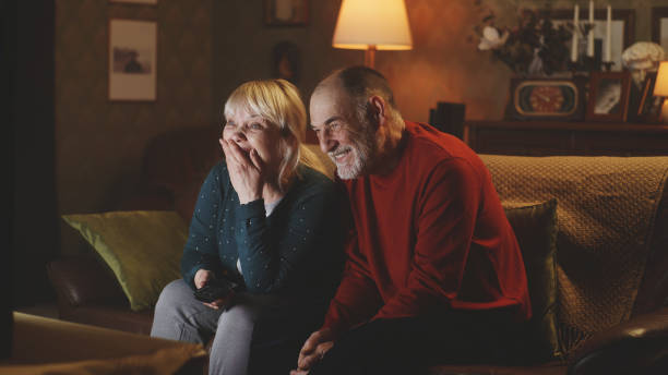 Cheerful elderly couple laughing during showtime