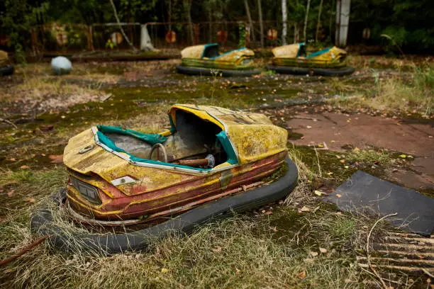 Abandoned bumper cars in the amusement park in ghost town of Pripyat city in Chernobyl Exclusion Zone, Ukraine