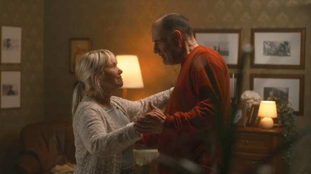 istock Elderly couple dancing in living room 1388562505