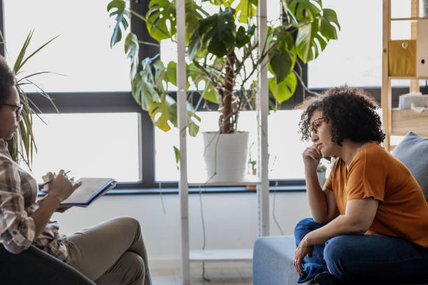 istock Encouraging therapist talking with a patient 1388564532
