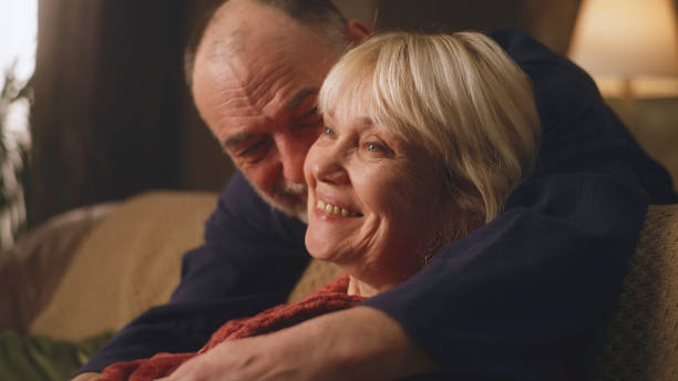 istock Aged man and woman hugging together 1388564551