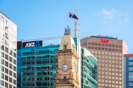 Adelaide, South Australia - August 19, 2019: Old General Post Office clock tower with modern office buildings behind on Victoria Square on a day