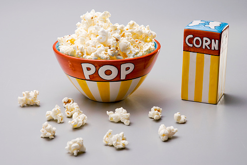 Yellow and red set of ceramic bow, with popcorn, and salt dispenser, isolated