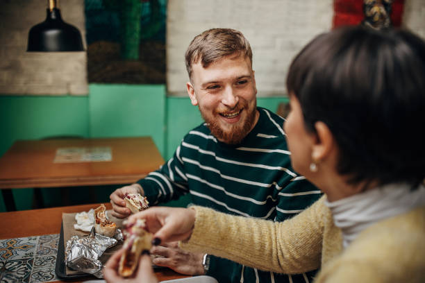 istock Couple eating burritos 1388569640