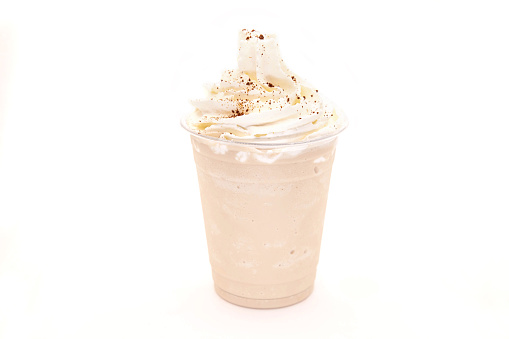 Vanilla coffee frappe with whipped cream and crushed coffee bean grains.