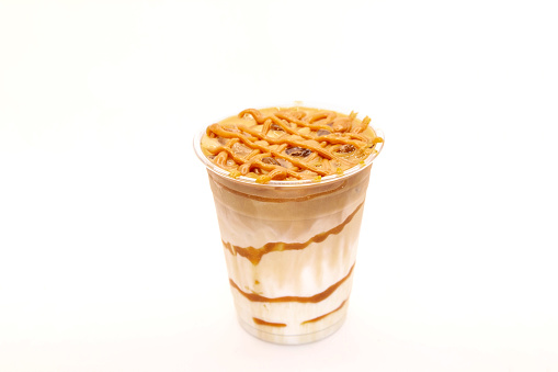 Caramel Macchiato with caramel dressing on top in a to go disposable cup.