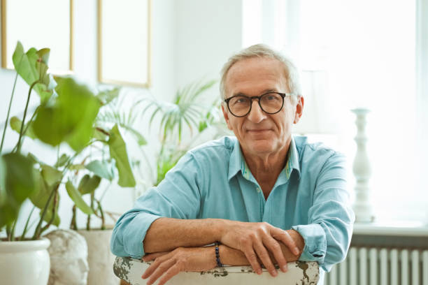 istock Senior man sitting on chair at home 1388570047