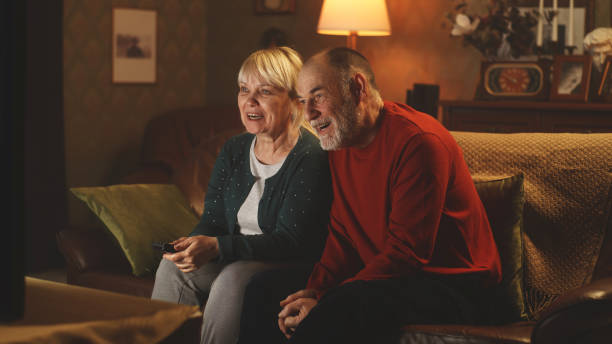 istock Optimistic senior husband and wife discussing comedy 1388571328