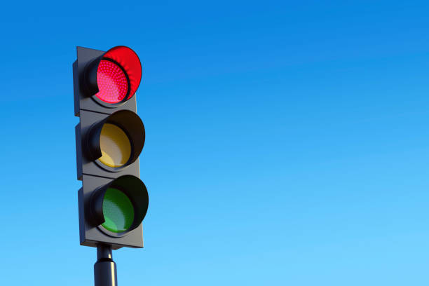 Red traffic light against sky stock photo