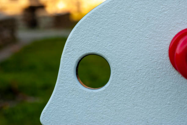 Eye shaped hole in swing seesaw in playground with copy space