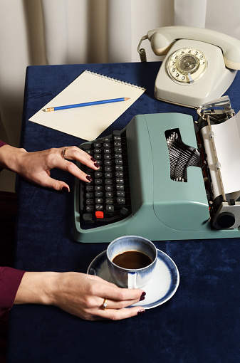Woman working with vintage typewriter