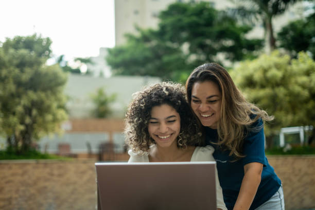 istock Mother and daughter using laptop in hotel 1388575953