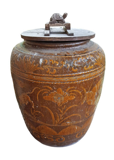 istock Ancient pottery jar with wooden lid on whtie background 1388577217