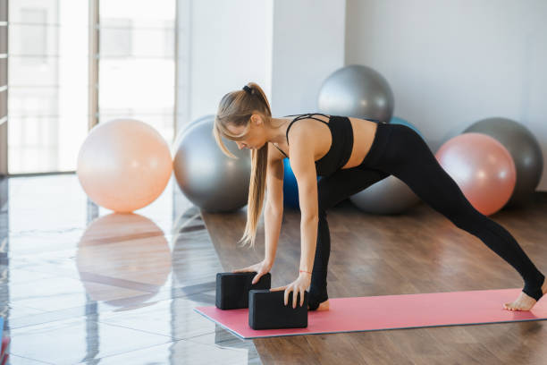 istock Athletic woman exercising with yoga blocks 1388577496